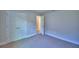 Bedroom with closet doors, carpeting, and access to other rooms at 4300 Juliana Lake Dr, Auburndale, FL 33823