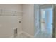 Practical laundry area includes storage, utilities, and access to the hallway bathroom at 4300 Juliana Lake Dr, Auburndale, FL 33823