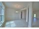 Bright living room with tile floors, classic molding, and a modern chandelier at 4300 Juliana Lake Dr, Auburndale, FL 33823