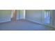 Spacious living room features neutral walls and carpet; offers multiple entry points at 4300 Juliana Lake Dr, Auburndale, FL 33823
