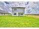 Back of the house and yard on a sunny day with bright green grass at 4449 Juliana Lake Dr, Auburndale, FL 33823