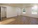 Sunlit bedroom with hardwood floors, two windows, and a closet at 445 Silverbell Trl, St Cloud, FL 34771
