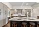 Kitchen with stainless steel appliances, gray cabinets, marble countertop and barstool seating at the island at 4642 Highlands Place Dr, Lakeland, FL 33813