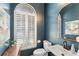 Powder room featuring dark blue walls, white trim, a dark wood vanity and a rounded mirror at 4642 Highlands Place Dr, Lakeland, FL 33813
