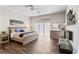 Bright bedroom featuring wood floors, a ceiling fan, a decorative fireplace, and ample natural light at 4642 Highlands Place Dr, Lakeland, FL 33813
