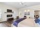 Spacious bedroom featuring wood floors, a ceiling fan, a decorative fireplace, and ample natural light at 4642 Highlands Place Dr, Lakeland, FL 33813