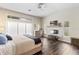 Bright bedroom featuring wood floors, a ceiling fan, a decorative fireplace, and ample natural light at 4642 Highlands Place Dr, Lakeland, FL 33813