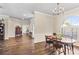 Bright dining room with hardwood floors, chandelier, and view of the entry hall at 4642 Highlands Place Dr, Lakeland, FL 33813