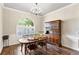 Dining room featuring wood floors, traditional furniture, crown molding, and an arched window at 4642 Highlands Place Dr, Lakeland, FL 33813