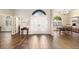 Foyer with double doors, wood-look tile, an arched transom window, and dining room in the background at 4642 Highlands Place Dr, Lakeland, FL 33813