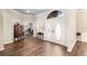 Foyer with double doors, wood-look tile, an arched transom window, and a glimpse into an office at 4642 Highlands Place Dr, Lakeland, FL 33813