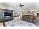 Open-concept living room with a large rug, sofa, and entertainment center next to the kitchen at 4642 Highlands Place Dr, Lakeland, FL 33813