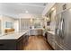 Bright kitchen with a center island, gray cabinets, stainless steel appliances, and hardwood floors at 4642 Highlands Place Dr, Lakeland, FL 33813