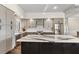 Modern kitchen boasts gray cabinets, stainless steel appliances, and a large center island at 4642 Highlands Place Dr, Lakeland, FL 33813