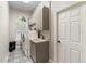 Laundry room featuring updated washer and dryer, stylish floor tiles, and sink at 4642 Highlands Place Dr, Lakeland, FL 33813
