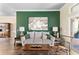 Cozy living room featuring a stylish sofa, dark wood floors, and accent wall at 4642 Highlands Place Dr, Lakeland, FL 33813