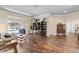 Spacious living room with hardwood floors, sliding glass doors to a screened in patio, and pool view at 4642 Highlands Place Dr, Lakeland, FL 33813