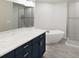 Modern bathroom featuring dual vanities, a soaking tub, and a glass-enclosed shower at 470 Windy Willow Way, St Cloud, FL 34771