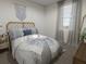 A cozy bedroom featuring a woven headboard, decorative accents, and soft window coverings at 470 Windy Willow Way, St Cloud, FL 34771