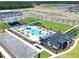 Aerial view showcasing the community's amenities, including a pool, playground, and green space at 485 Silverbell Trl, St Cloud, FL 34771