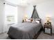 Bright bedroom with window and teepee decor over bed with matching side tables at 485 Silverbell Trl, St Cloud, FL 34771
