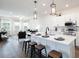 Modern kitchen with stainless steel appliances, white cabinets, large island, and bar stool seating at 485 Silverbell Trl, St Cloud, FL 34771