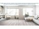 Bright living room featuring vinyl plank flooring, white walls, and large windows for natural light at 485 Silverbell Trl, St Cloud, FL 34771