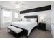 Serene main bedroom with a ceiling fan, large window, and neutral color scheme at 485 Silverbell Trl, St Cloud, FL 34771