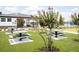 Community picnic area with tables surrounded by beautiful landscaping and flowering trees at 485 Silverbell Trl, St Cloud, FL 34771