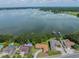 Stunning aerial view of lakefront homes, showcasing the expansive lake and the serene landscape surrounding the properties at 5026 N Socrum Loop Rd, Lakeland, FL 33809
