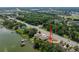 Aerial view of lakefront home with a sprawling yard and private dock, lush greenery, and waterfront access at 5026 N Socrum Loop Rd, Lakeland, FL 33809