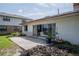 The back of the house shows a concrete patio with potted plants and nice lake views through sliding glass doors at 5026 N Socrum Loop Rd, Lakeland, FL 33809