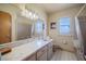Bathroom showcasing marble countertop vanity, with a tub-shower combination, offering comfort and practicality at 5026 N Socrum Loop Rd, Lakeland, FL 33809
