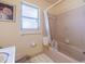 Compact bathroom featuring a shower-tub combo, ensuring all essential amenities are available in a cozy space at 5026 N Socrum Loop Rd, Lakeland, FL 33809