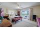 Bright bedroom with ceiling fan, plush carpeting, and sliding glass doors with lake views at 5026 N Socrum Loop Rd, Lakeland, FL 33809