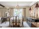 Formal dining room featuring a chandelier, and large windows with lake views at 5026 N Socrum Loop Rd, Lakeland, FL 33809