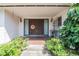 Inviting front porch leading to double front doors and flowering plants at 5026 N Socrum Loop Rd, Lakeland, FL 33809