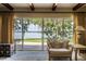 Bright sitting area with lake views visible through large sliding glass doors for indoor/outdoor living at 5026 N Socrum Loop Rd, Lakeland, FL 33809