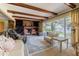 Spacious living room boasting exposed beams, fireplace, and large windows with water views at 5026 N Socrum Loop Rd, Lakeland, FL 33809