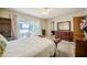 Bright main bedroom featuring a large window with water views and ensuite bathroom for added convenience at 5026 N Socrum Loop Rd, Lakeland, FL 33809