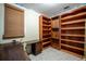 Home office with built-in wooden bookshelves, desk, and large windows for a bright, productive workspace at 5026 N Socrum Loop Rd, Lakeland, FL 33809