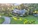 Aerial view of a charming single-Gathering home with a long porch, mature trees, and landscaped yard at 5108 Waterwood Dr, Bartow, FL 33830