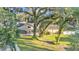 Scenic aerial view of home featuring a screened-in porch and lush lawn shaded by mature trees at 5108 Waterwood Dr, Bartow, FL 33830