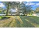 Large backyard with mature trees providing shade and privacy, along with a fenced perimeter at 5108 Waterwood Dr, Bartow, FL 33830