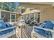Backyard brick patio with white furniture and outdoor access at 5108 Waterwood Dr, Bartow, FL 33830