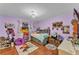 Cozy bedroom featuring hardwood floors, a ceiling fan and purple colored walls at 5108 Waterwood Dr, Bartow, FL 33830