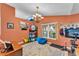 Bedroom with vaulted ceiling, chandelier, window, and comfortable seating on a hardwood floor at 5108 Waterwood Dr, Bartow, FL 33830