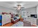 Bright bedroom with ceiling fan, hardwood floor and colorful decor at 5108 Waterwood Dr, Bartow, FL 33830