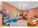 Bedroom with vaulted ceiling, chandelier, window, and comfortable seating on a hardwood floor at 5108 Waterwood Dr, Bartow, FL 33830