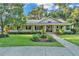 Charming single-story home features a large front porch, manicured lawn, and lush landscaping at 5108 Waterwood Dr, Bartow, FL 33830